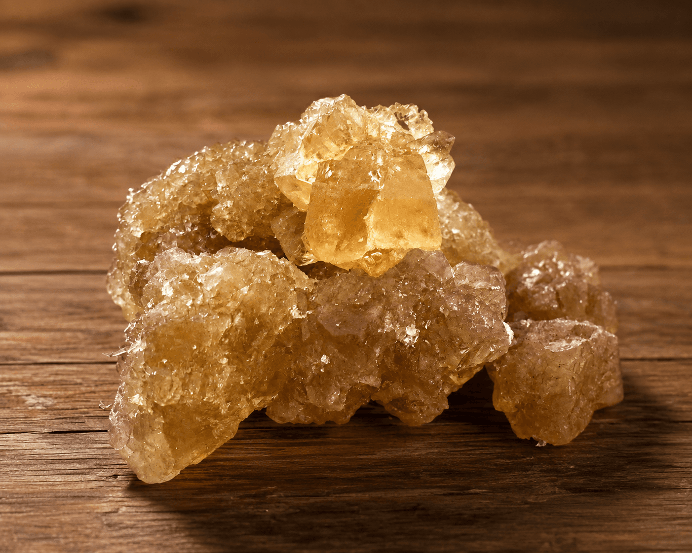 Natural amber-brown Mishri crystals in warm sunlight