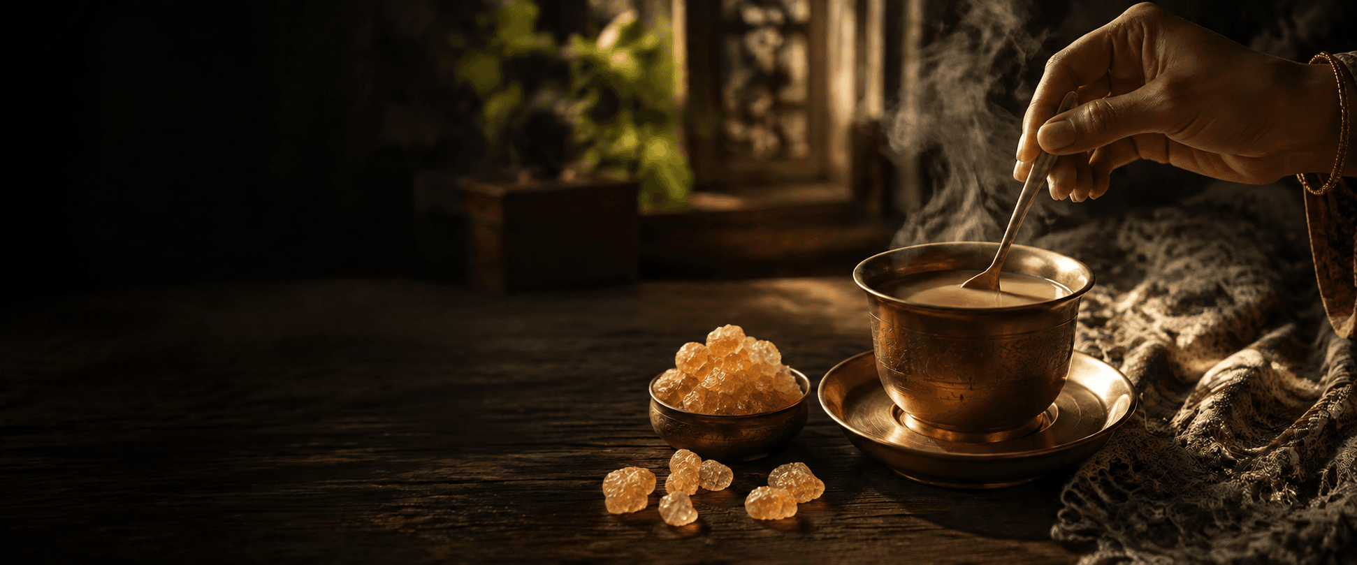 Brown Mishri beside a brass cup of morning chai